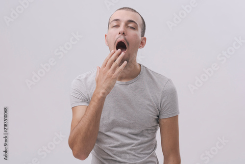 Obraz na plátne Yawning Man Covering His Mouth