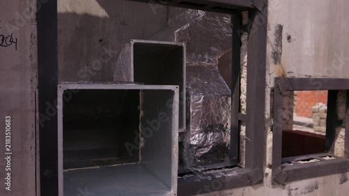 Rectangular ventilation ducts installed in concrete wall openings