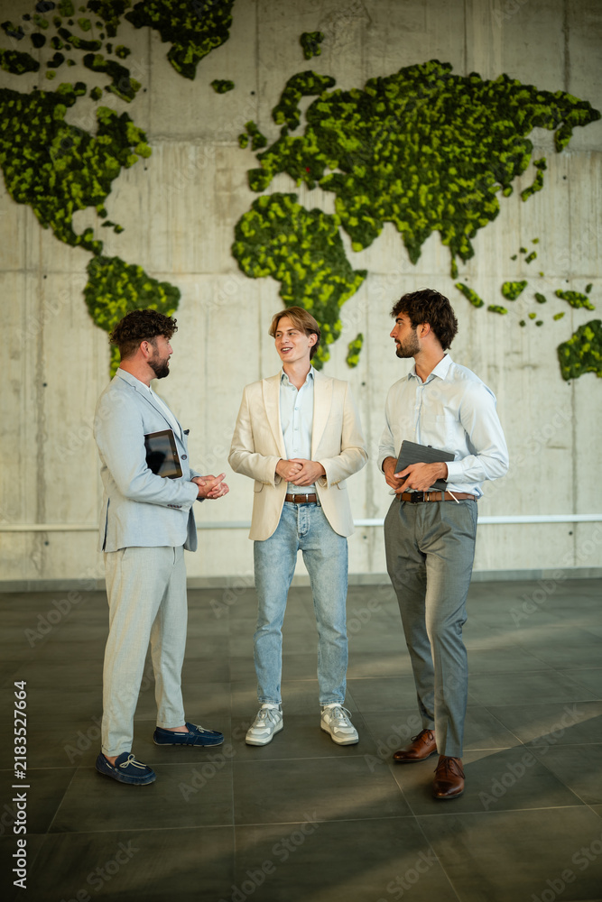 Fototapeta premium Business men discussing global strategy in modern office