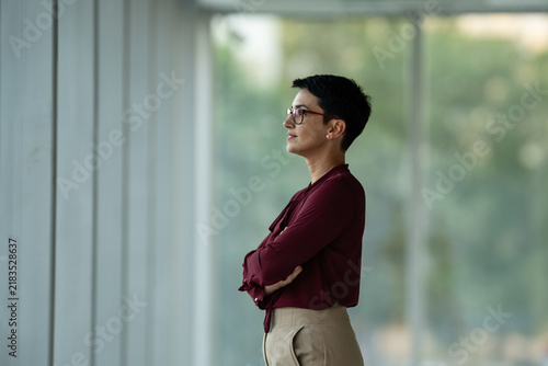 Obraz na plátne Businesswoman looking through window envisioning future success