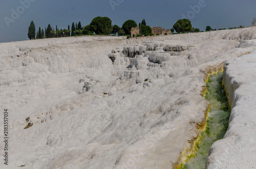 Pamukkale Turkey travertine terraces white mineral formations thermal springs ancient landscape blue sky natural wonder tourism destination geology calcium pools