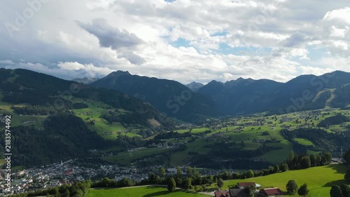 Aerial drone view of Planai mountain and the town of Schladming in the Austrian Alps. The alpine landscape while dark storm clouds gather over the mountains creating a dramatic atmosphere