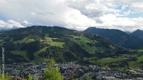 Aerial drone view of Planai mountain and the town of Schladming in the Austrian Alps. The alpine landscape while dark storm clouds gather over the mountains creating a dramatic atmosphere