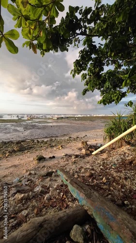 Tropical shoreline with fishing boats during low tide