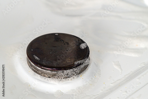 Photography Gas stove surface with sprayed cleaning agent to pre-dissolve dirt
