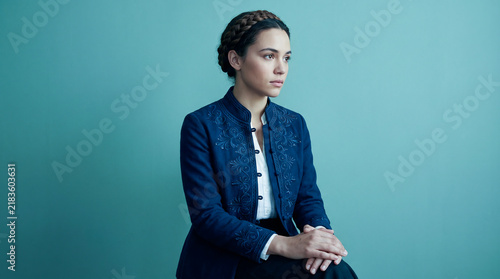 Elegant Young Woman with Braided Hairstyle in Embroidered Navy Blue Jacket