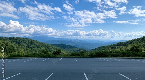 Expansive vista of rolling green mountains under a vast, cloud-dotted blue sky