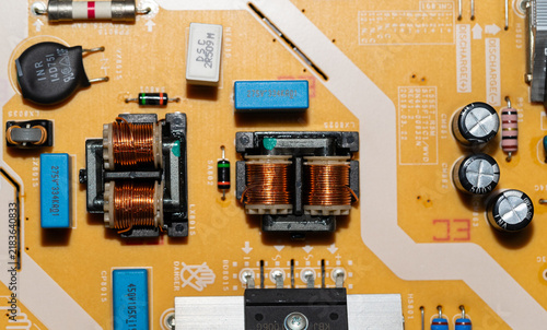 Konstfotografi Electronic power supply board with copper coils and capacitors close up