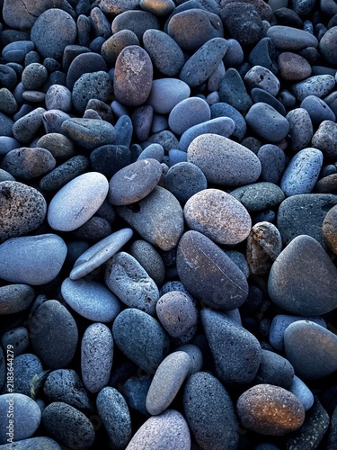 Natural smooth sea pebbles texture on rocky beach
