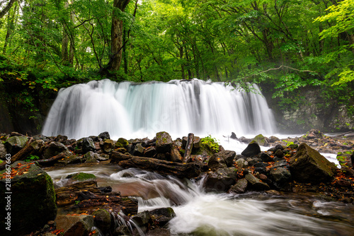 Choshi Otaki Waterfall surrounded by fresh green forest in Oirase Gorge, Aomori, Japan