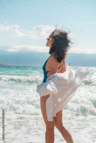 Woman in swimsuit standing on Croatia beach