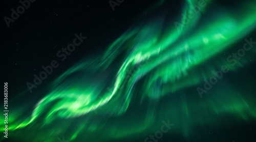 Emerald Aurora Borealis Light Streaks Flowing Across a Starry Night Sky