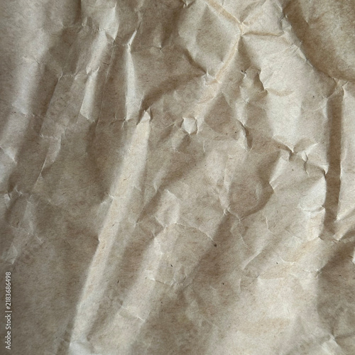 Принти на полотні Crumpled brown craft paper texture with folds and creases