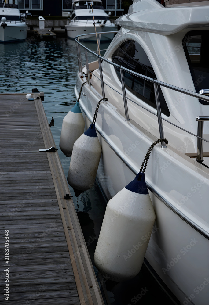 Obraz premium Luxury yacht travel and maritime leisure, white boat moored at wooden pier with protective fenders for docking in a calm marina harbor during summer