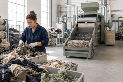 Worker Sorting Textile Waste at Recycling Facility