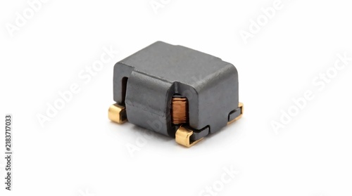Electronic surface mount power inductor component featuring copper windings and ferrite core isolated on a clean white professional background surface