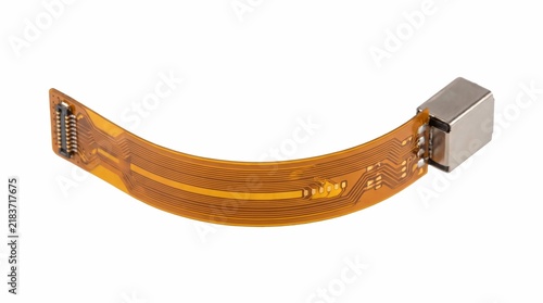 Flexible brown ribbon cable with a metallic connector attached isolated on white background for modern electronic device repair hardware components