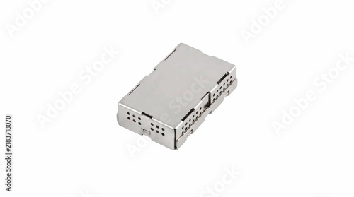 Small rectangular stainless steel surgical sterilization basket with perforated sides used for organizing medical tools in a professional hospital setting clinic