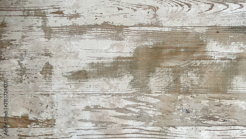 Obraz na płótnie Old white-painted wood planks with broad scraped areas, exposed beige grain, and