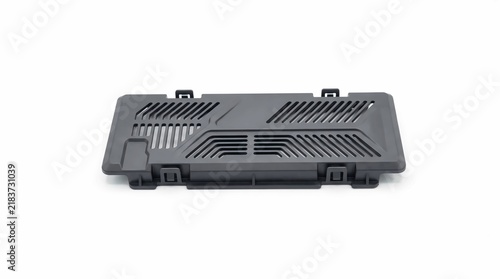 Black plastic laptop ventilation cover features precise geometric cooling slots designed for efficient heat dissipation on high performance electronic devices