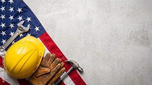 Construction tools and safety gear arranged on an American flag for Labor Day concept.