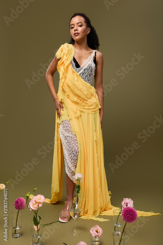 Bild auf Leinwand Stunning African American woman showcases elegance in a stylish outfit with flow