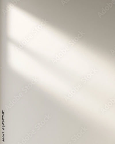 Soft window shadow on a beige wall. Minimalist abstract background with sunlight and diagonal shadow lines