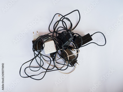 Tangled Cable Mess with Power Adapters and Chargers for Electronic Devices Concept