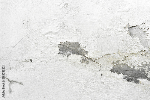 Peeling painted concrete wall. Leaking rain cause the wall and ceiling cracked.