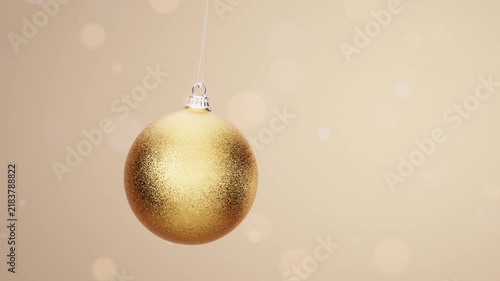 Golden Christmas bauble on elegant soft bokeh background loop