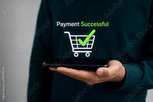 Hand holding tablet displaying successful payment confirmation with green shopping cart icon