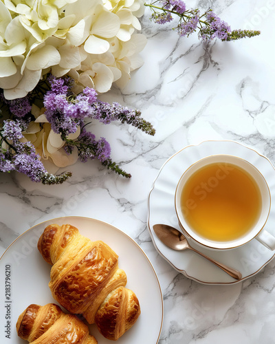 Elegant Afternoon Tea with Fresh Croissant and Floral Arrangement on Marble Table