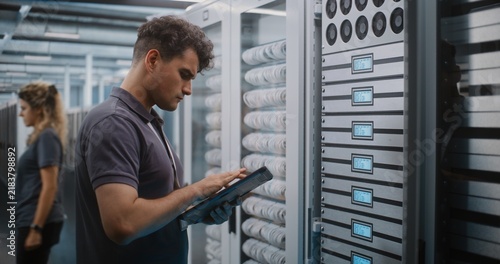IT Specialist Holds Digital Tablet and Uses Keys to Open Glass Server Cabinet Door Inspect Cooling Fans and Hardware Components. System Diagnostics, Physical Maintenance Ensure Optimal Server Airflow.