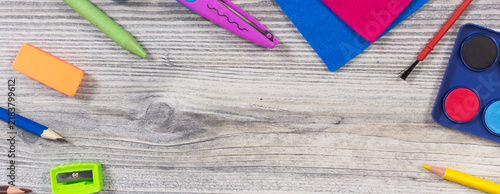 Different school supplies and stationery accessories using for development of creativity and kids motor skills. Place for text