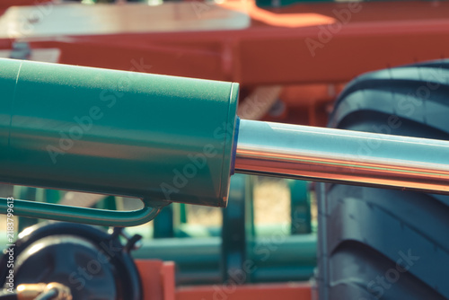 Green pistons or actuators in red pneumatic or hydraulic machine. Technology