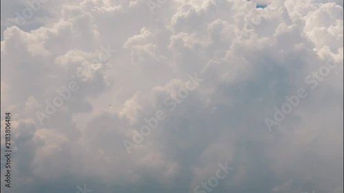 White puffy clouds drifting across a bright blue sky during a sunny afternoon capturing nature in motion
