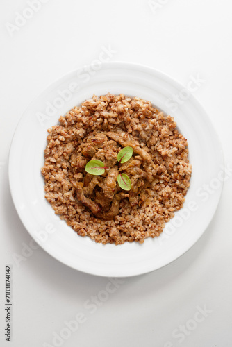 Canvastavla plated dish with toasted buckwheat groats surrounding tender seared meat slices, finished with bright green microgreens