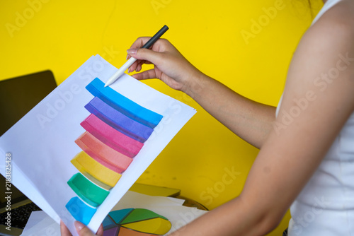 hands of a woman painting a picture