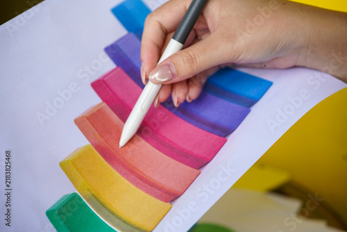hands of a woman painting a picture