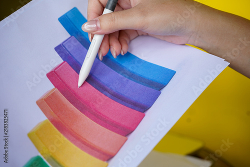hands of a woman painting a picture