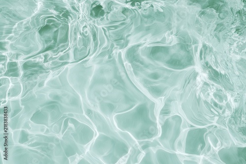Water surface reflecting light in a pool during the daytime