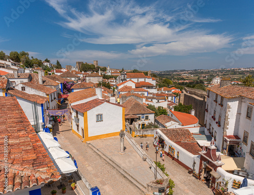 Elevated view of whitewashed houses, traditional streets, and ancient fortifications in Obidos, Portugal