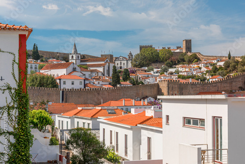 Panoramic cityscape of Obidos showing historic fortifications, white houses, and terracotta roofs - Portugal