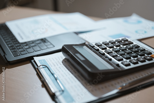 Принти на полотні Investment decisions use analysis of financial records and data on growth from printed graphs under a dark keypad, where investment choices depend on analysis of financial records and data on growth