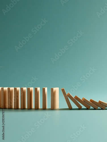 Falling dominoes stopped by one block concept