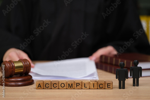In a quiet courtroom, a judge prepares to address the case.