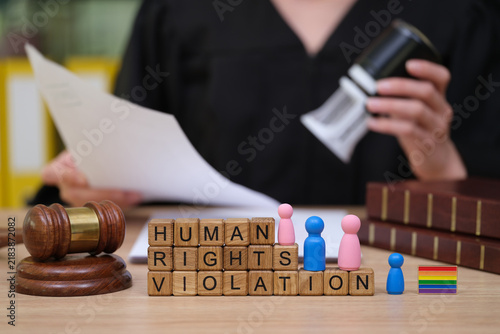 Bild auf Leinwand Courtroom scene shows a judge with a gavel discussing human rights violations