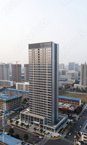 modern building stands vast urban development site mix finished structures amidst cityscape