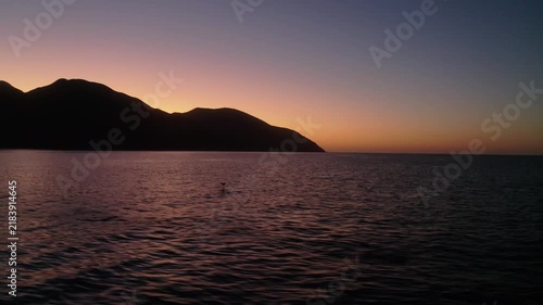 4K drone video of wild mobula rays jumping out of the sea water during a beautiful sunset in La Ventana, Baja California Sur.