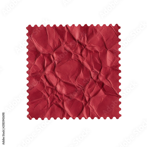 A square piece of red wrinkled paper with jagged edges isolated on a simple plain surface for craft design
